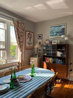 a dining room table with plates and glasses on it