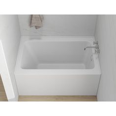 a white bath tub sitting inside of a bathroom