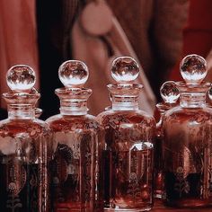 several glass bottles are lined up on a table