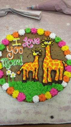 a decorated cake with two giraffes on it