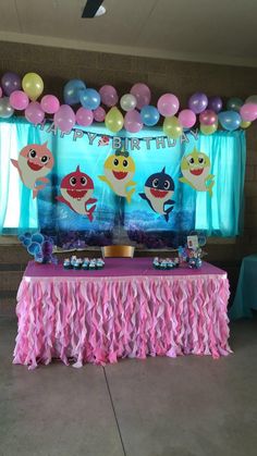 an under the sea themed birthday party with pink and blue decorations, balloons and streamers