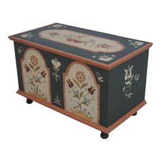 an ornately painted chest on wheels with floral designs