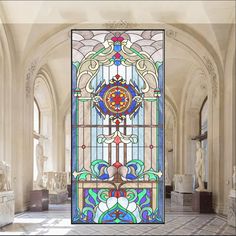 an ornate stained glass window in the middle of a room with marble columns and arches