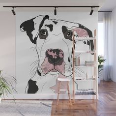 a dog's face is shown on the wall next to a ladder and potted plant