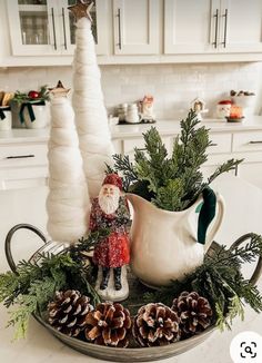 a christmas centerpiece with pine cones, greenery and a gnome figurine