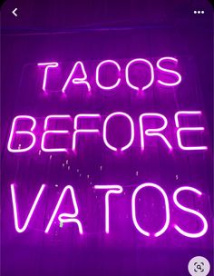 a neon sign that says tacos before vatos