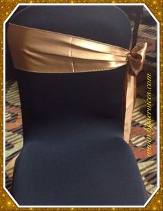 the back of a chair with a gold bow on it's seat belted