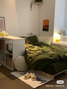 a bed with green sheets and pillows in a room