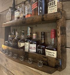 a wooden shelf with bottles and glasses on it