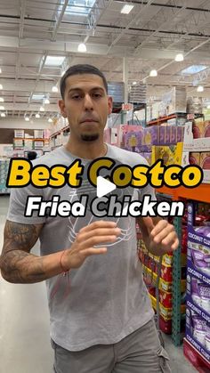 a man is standing in a store with his hand up to the camera and he has an advertisement for best costo fried chicken