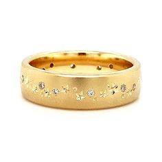 This beautiful band is crafted in buttery 14K yellow gold, the sand-blasted finish creating a matte surface that seems to glow, glittering diamonds interspersed with perfectly hand-engraved stars, planets, and moons running down the center. Wear this as a fashionable wedding band or add it to a stack of your favorite rings! Cold Hard Facts: metal: 14K yellow gold gem: (13) round brilliant cut white diamonds - 0.20ctw (G-H, SI1) shank width: approx. 6mm finger size: 6.5 Celestial Wedding Band, Star Wedding Band, Planets And Moons, Celestial Ring, Bozeman Mt, Star And Moon, Yellow Gold Diamond Ring, Diamond Glitter, Gold Diamond Ring