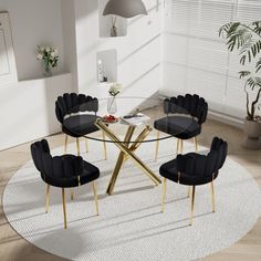 a round glass table with black chairs around it in a white living room, next to a potted plant