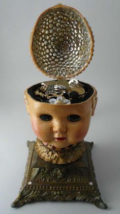 an antique doll with a hat on top of it