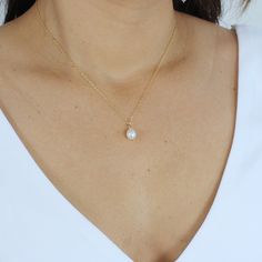 Indulge in the allure of our Cassie Single Pearl Necklace. this minimalist design features a Genuine Freshwater Pearl drop on a dainty chain. It's simple and sweet, with a subtle sparkle that makes it the perfect focal point for any bride.  The delicate design makes this a versatile piece that can be layered with other necklaces or worn solo. Whether you're looking to wear it on your wedding day or show it off at a night out with your girls, this piece will fit into any look. Our Cassie necklace Dainty Pearl Necklace, Single Pearl Necklace, Gold Pearl Necklace, Real Pearls, Handcrafted Necklace, Earrings Collection, Pearl Drop, Cultured Pearls, Pearl Pendant