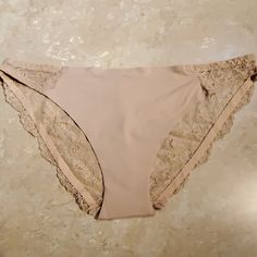 Free Cut Panty By Shimera. Bikini Style. Nude Nylon Blend For An Almost Nothing Feel. Seamless Design Helps Eliminate Panty Lines. Sheer Lace Back. Nylon/ Spandex Blend Size: Small Nwot Feminine Stretch Brief Swimwear, Feminine Seamless String Bottoms, Lace Trim Brief Bottoms For Beach, Elegant String Beach Bottoms, Elegant Beach String Bottoms, Bikini Style, Lace Back, Sheer Lace, Women's Intimates