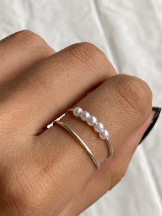 - DOUBLE LAYER ANXIETY RING - How they help: - These rings stop bad habits like picking at your fingers or lips when anxious and are also fun to fidget with :)  - All rings measure 7 (US size), N 1/2 (UK size), diameter= 17.32mm & circumference = 54.4mm and are adjustable to accommodate for similar sizes. IF YOU REQUIRE A LARGER OR SMALLER SIZE LEAVE A NOTE WHILE PLACING THE ORDER - silver plated copper 18 gauge wire with faux pearls which may tarnish so if you would like a long lasting ring tha Silver Fidget Ring, Fidget Rings Jewelry, Dainty Silver Rings, Minimal Silver Ring, Dainty Rings, Ring Pearl, Worry Ring, Fidget Rings, Minimal Jewelry