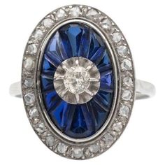 Beautiful old cluster ring made of white gold and platinum. Its central point is a diamond in an old brilliant cut weighing approx. 0.20ct. An old oval-shaped ring decorated with faceted sapphires in a carre cut and numerous diamonds in a rose cut. Origin: France, 1920s-1930s. Preserved hallmark "eagle head". Dimensions of the decorative element: 21mm x 15mm Weight: 4.5g. Ring size: 19 (59) - possible size correction. Gemmological laboratory certificate included Art Deco Oval Sapphire Ring In Platinum, Art Deco Oval Cluster Ring In Platinum, Art Deco Oval Platinum Diamond Ring, Victorian Sapphire Ring With Diamond Oval Shape, Victorian Oval Sapphire Ring With Diamond, Oval Platinum Diamond Ring With 17 Jewels, Vintage Sapphire Ring With Diamond Cut, Oval Shape, Vintage Oval Sapphire Ring With Diamond Cut, Antique Oval Sapphire Ring With Diamond Accents