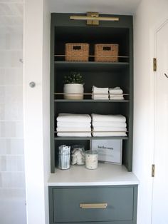 an organized closet with folded towels and other items