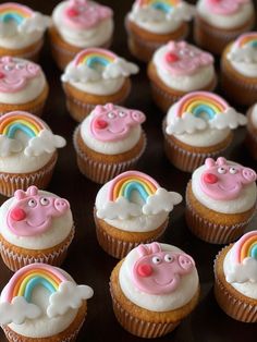 cupcakes with pink frosting and rainbow decorations