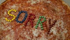 a pizza with beads spelling out the word pop on it's top and bottom