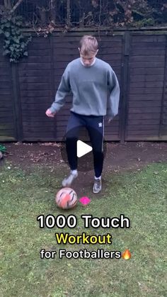 a young boy kicking a soccer ball in the yard