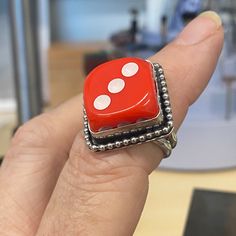 Handcrafted Red Dice Ring--a whimsical creation that adds a touch of playful charm to your ensemble.  Crafted with care in my studio, this ring features a bright red dice that I sawed in half.  To enhance the intricate details of this sterling silver ring, I've added a subtle patina, lending an antique allure to the sterling metal while highlighting its unique features.  Whether worn as a whimsical homage to Las Vegas or as a symbol of luck and adventure, this handcrafted  dice ring is sure to turn heads and spark conversation wherever you go. I enjoy making these little whimsical treasures. I hope you love your new ring! Ring size 8   Your ring will arrive in a cute gift box.  Handmade in my studio in Phoenix, Arizona Dice Ring, Red Dice, Symbol Of Luck, Gift Box Handmade, Cute Gift Boxes, Box Handmade, Unique Features, Phoenix Arizona, Phoenix Az