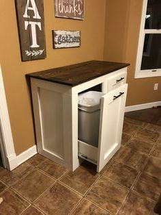 a kitchen island with a trash can underneath it