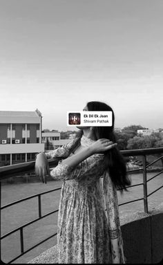 a woman standing on top of a bridge with her arms around another woman's neck