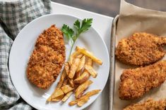 fried fish and french fries on a plate next to a box of breaded potato wedges