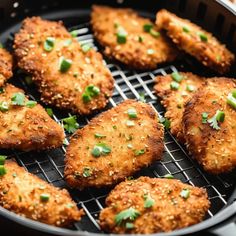 chicken patties are cooking in a skillet on the stove top with parsley