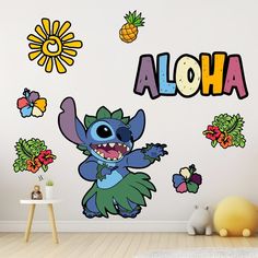 a child's room with a wall decal featuring the name aloha