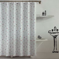 a white shower curtain with red and black polka dots on it next to a sink