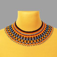 a multicolored beaded necklace is displayed on a mannequin neckline