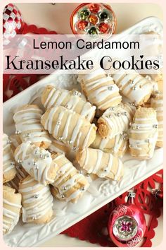 lemon cardamom kranisake cookies on a white platter with candy in the background