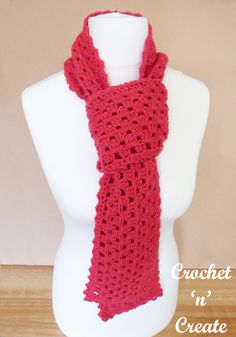 a red crochet scarf on a mannequin