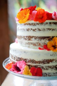 a three layer cake with flowers on top