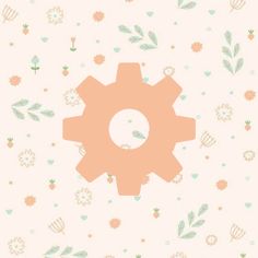 a pink and green flowered wallpaper with an orange cogwheel on it