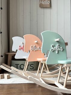 three wooden rocking chairs with names on them