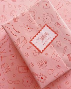 pink wrapping paper with small drawings on it