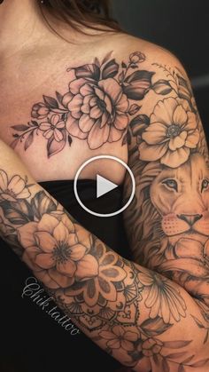 a woman's arm with flowers and a lion on it