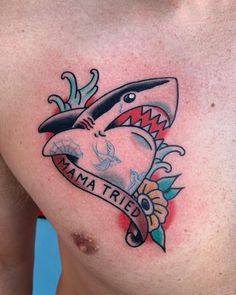 a man's chest with a shark tattoo on it and the words mama tried