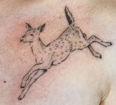 a small deer tattoo on the chest