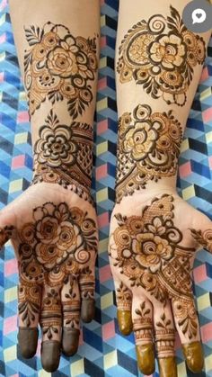 two hands with henna designs on them