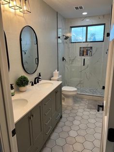 a bathroom with a sink, toilet and shower in it's center piece is shown