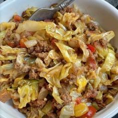 a white bowl filled with cabbage and meat