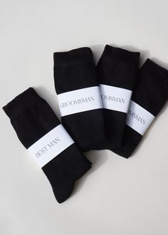 four black socks with white labels on them