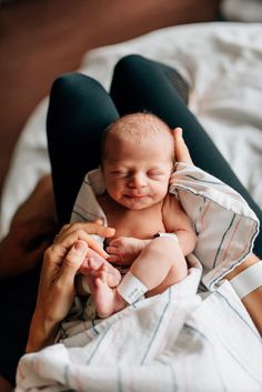 a woman holding a baby in her arms