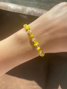 Yellow bead bracelet with a delicate design. The Floral Daisy Bracelet will brighten up your look. A beaded bracelet crafted by hand with high-quality beads.  Thank you very much for visiting our shop. We hope you have a great shopping experience! If you are struggling to find the information you need, please feel free to contact us. Do not forget to take a look at our other products in our shop. 😊 Yellow And White Beaded Bracelets, Cheap Elegant Yellow Beaded Bracelets, Yellow Bead Bracelet Ideas, Trendy Yellow Beaded Bracelets With Tiny Beads, Trendy Yellow Beaded Bracelets, Trendy Yellow Bracelets With Tiny Beads, Dainty Flower-shaped Beaded Bracelet With Colorful Beads, Dainty Flower-shaped Beaded Bracelets, Dainty Flower-shaped Beaded Bracelet