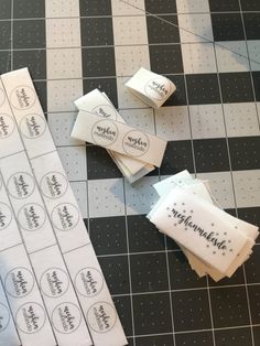 several pieces of paper sitting on top of a black and white checkered table cloth