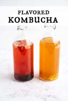 two bottles filled with liquid sitting on top of a white counter next to the words flavored kombucha